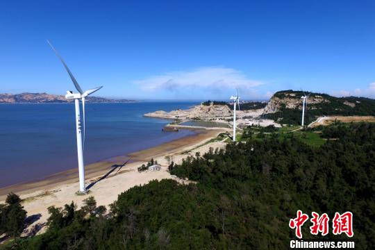 沿海灘而建的風力發電機。　王東明 攝